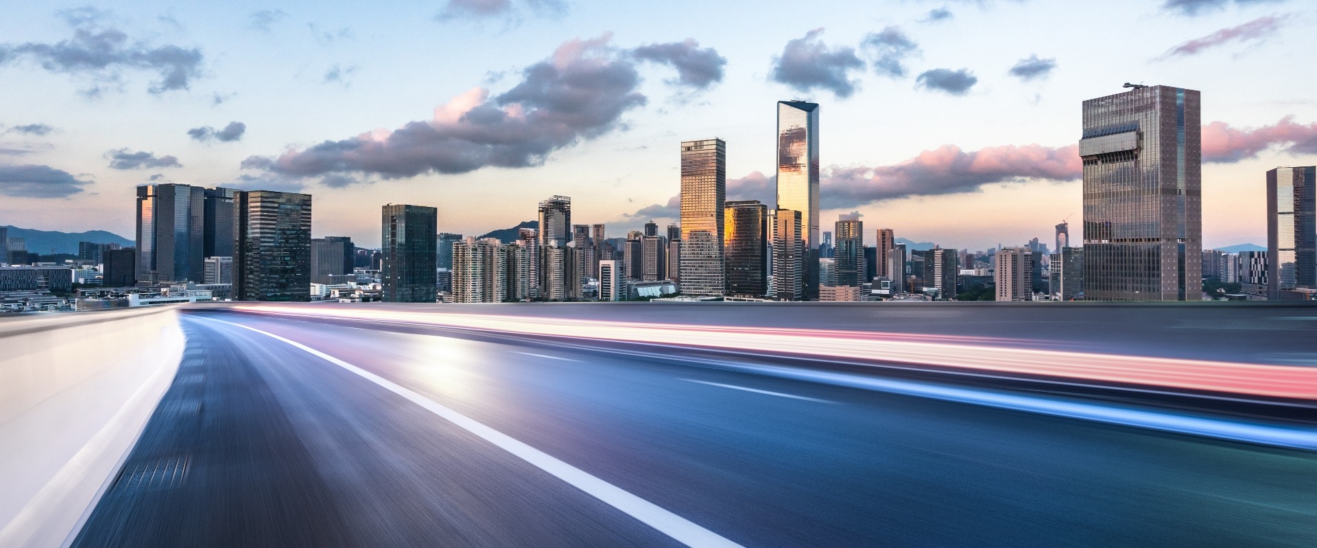 asphalt road with city skyline